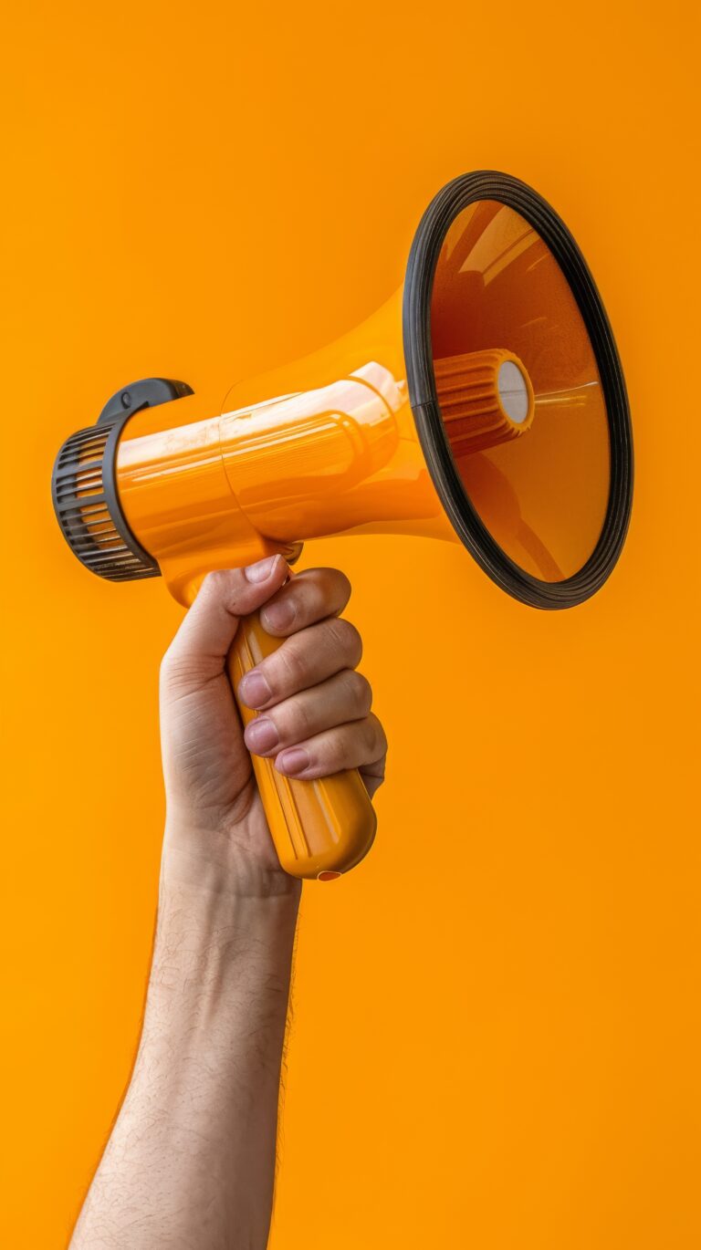 image-depicts-hand-holding-megaphone-against-orange-background-symbolizing-marketing