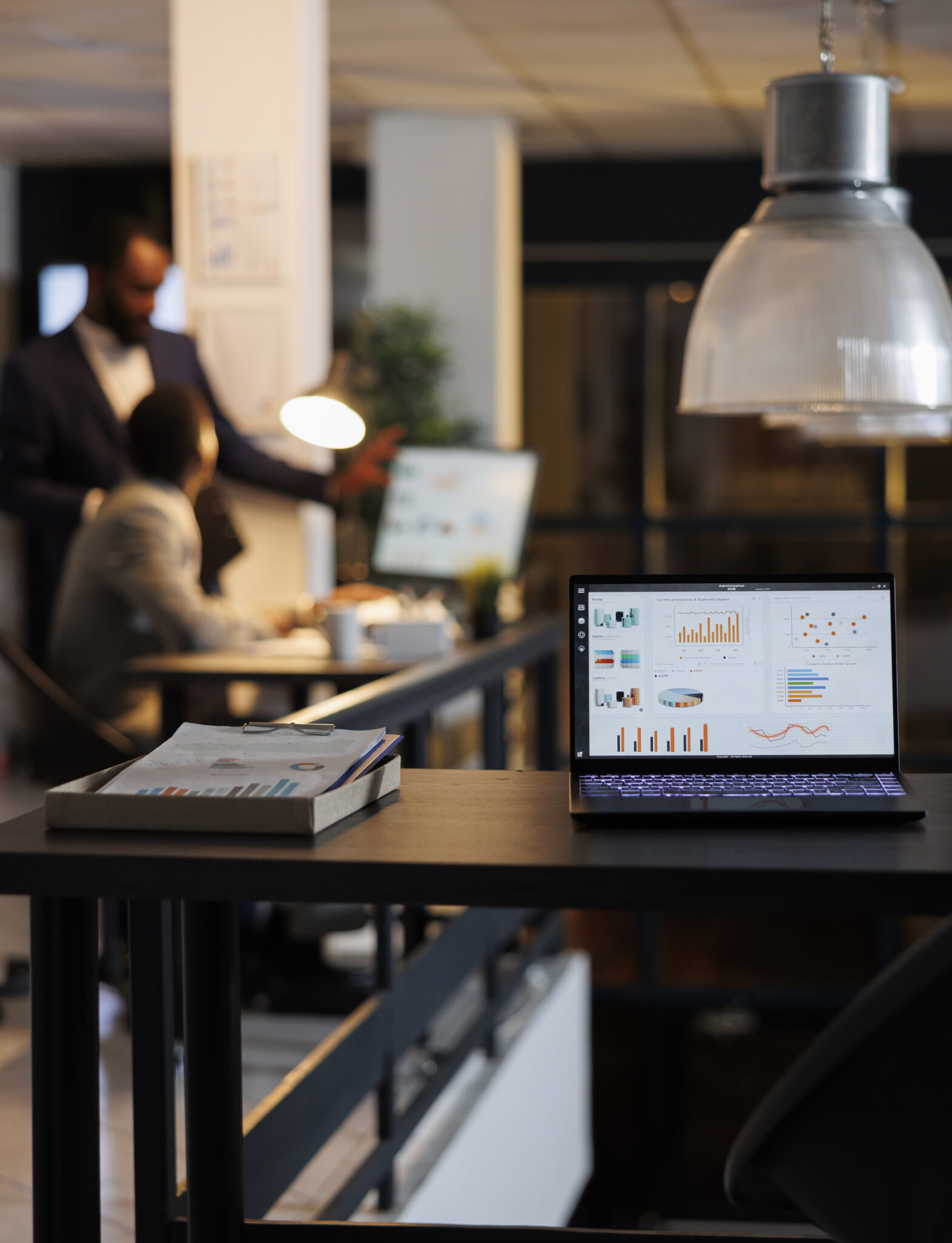 Laptop computer with financial graphs on screen